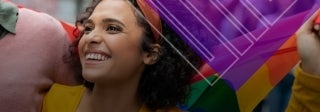 Woman smiling and holding a gay pride flag, Photo Credit: Rido on Shutterstock