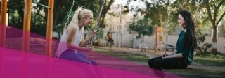 two women on a playground sitting on separate swings facing each other, photo credit Bewakoof.com Official/Unsplash