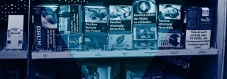 View of European cigarette packaging that has shocking images of health problems caused by smoking, photo credit Firn / Shutterstock