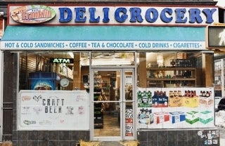 front of a deli grocery store, photo credit Robinson Greig / Unsplash