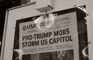USAToday Newspaper with header "Pro-Trump Mobs Storm US Capitol" in a machine, photo credit little plant/Unsplash