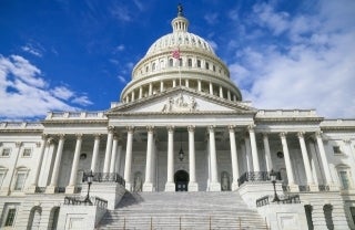 Front view of the US Capitol on a sunny day, photo credit Louis Velazquez / Unsplash