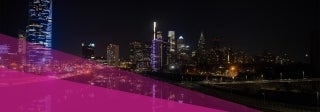 Night view of a river with a highway to the left and tall building on both sides,  Photo by Val on Unsplash