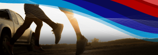 Silhouette of two joggers running in the sunset