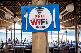 sign that reads free wifi inside; Photo by Bernard Hermant on Unsplash