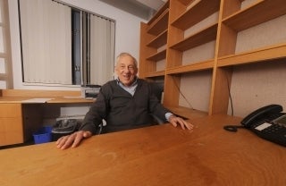 Elihu Katz seated behind a desk