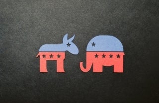 Red and blue paper cutouts of a donkey and an elephant