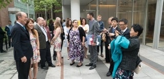 People taking graduation photos at an outside gathering