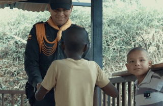 Colombian police officer playing with two children