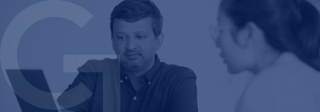 Photograph of Aswin Punathambekar, Ph.D. and Jing Wang, Ph.D. looking at a computer screen