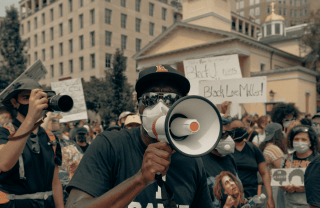 A man holds a megaphone at a Black Lives Matter protest in Washington D.C.