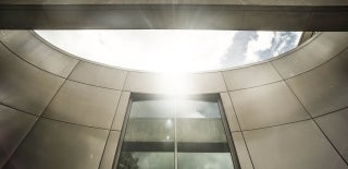 Decorative abstract angle of Annenberg Building architecture with the sun shining in the sky