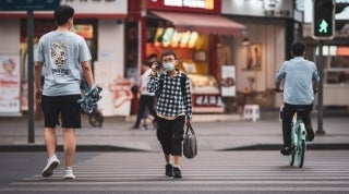 CDCSCovidFW_LiLinUnsplash.jpg Three people walking in a crosswalk and wearing face masks. Li Lin on Unsplash.