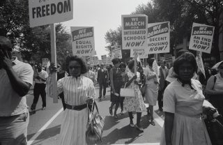 MLK_Event.jpg Women and men marching with signs in the 1960s during the Civil Rights Movement