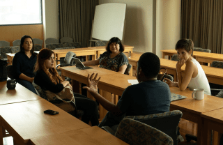 Left to right: Jocelin Monge, Mihaela Popescu, Katerina Girginova, Antoine Haywood, Esperanza Martinez sit in a classroom