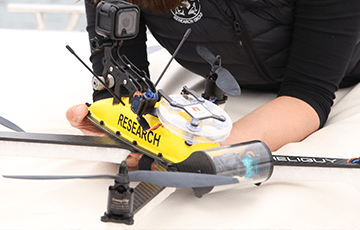 Woman in a boat holding an underwater research device
