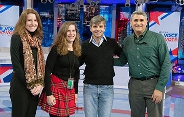Three alumni standing with George Stephanopolous on the ABC election night set