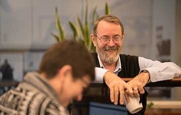 Bob Jamieson 360 x 230.jpg Man with coffee mug smiling at woman who is laughing