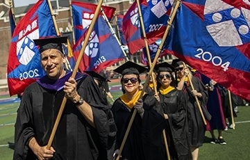 Penn alums carry class year banners at Commencement; Photo Credit: University of Pennsylvania