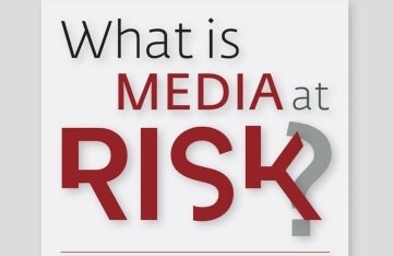 Graphic that says 'What is media at risk?". 'What is' is in written in a grey font, 'Media' is written below it starting at the 'h' in all-cops and red, and 'at' is in grey common letters. 'Risk' is in the third line and lines up with 'what' and is in red and a irregular font, and the question mark is grey and slightly behind the 'k' in risk.