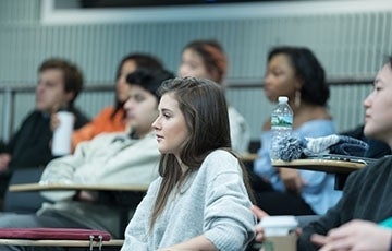 Students in a classroom watching someone off camera