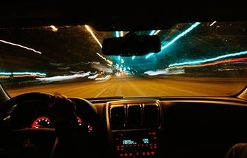 Car driving long exposure 360 x 230.jpg View from inside a car at night, looking out at the road ahead. A long exposure has created colorful trails from the lights