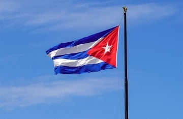 Cuban Flag with blue sky behind it