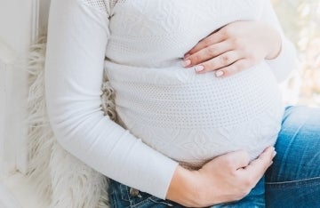 Pregnant woman with hands on belly