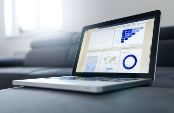Image of laptop with blue charts and graphs on it