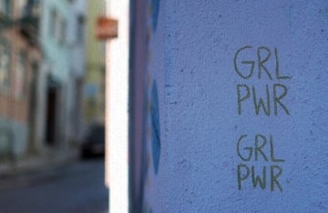 Blue wall with GRL PWR written on it twice
