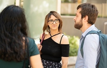 Three students talking outdoors