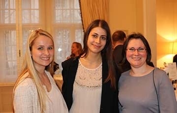 Three women posing for a photo indoors