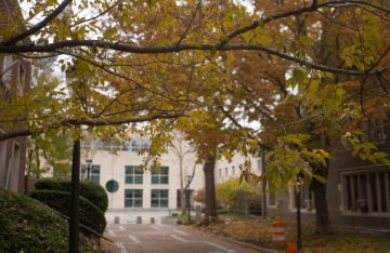The facade of the Annenberg building surrounded by autumn trees with yellow leaves