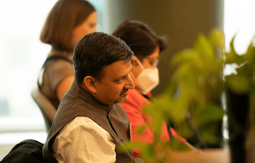 Aswin Punathambekar sits at a conference table