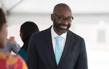 John Jackson in a suit and smiling