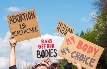 Protest Signs 1920 x 1250.jpg Hands holding protest signs reading: Abortion is Healthcare, Bans off our bodies, My Body My Choice, and Human Rights