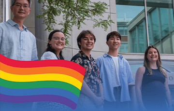 Andy Tan with students and an LGBTQ flag