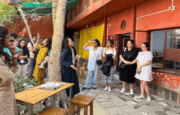 Students standing in an outdoor courtyard in India