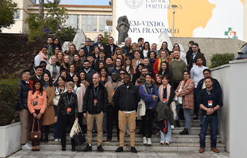 Group of students standing on stairs and smiling at camera
