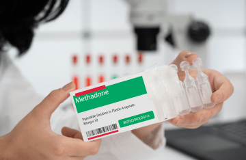 A doctor holding methadone medication