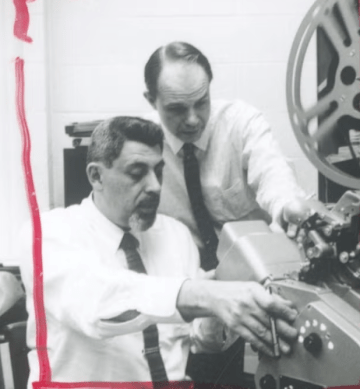 Ross Sol Worth working with a colleague on a film reel machine, February 1966