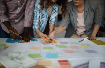 People with post its in a brainstorming meeting