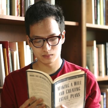Arthur Wang reading a book