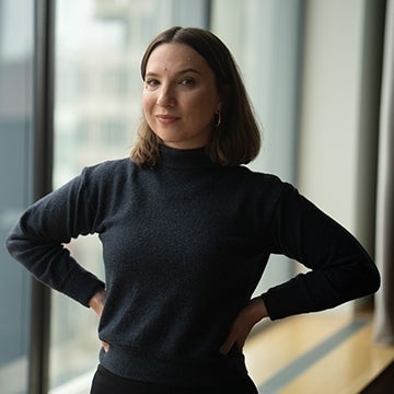 Kathryn Claire Higgins standing in front of window.