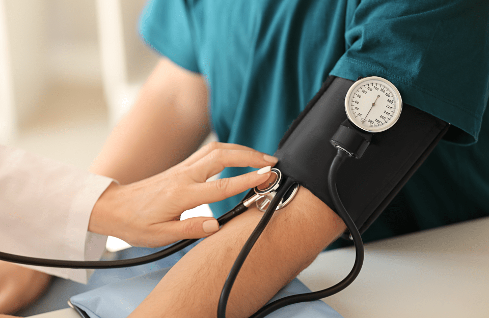 A person having their blood pressure taken with a blood pressure cuff