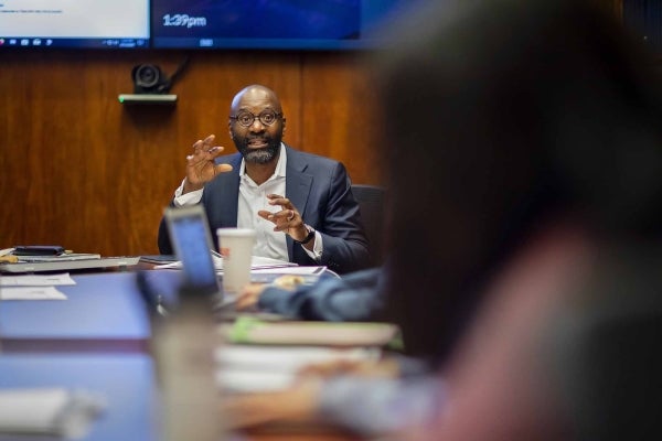 John Jackson at the head of a table teaching a class