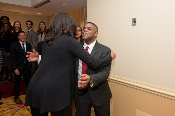 Barry Johnson hugs Michelle Obama