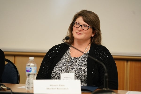 Picture of Alyssa Klein seated behind a microphone