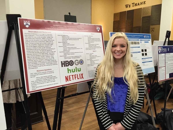Hope Mackenzie stands in front of her research project