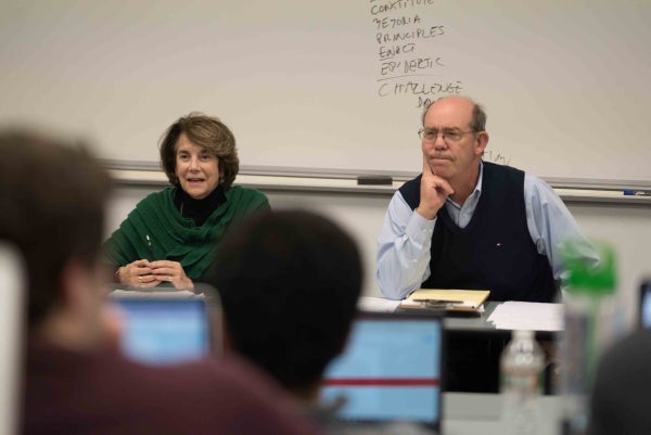 David Eisenhower and Marjorie Margolies sit at the front of a classroom listening to students